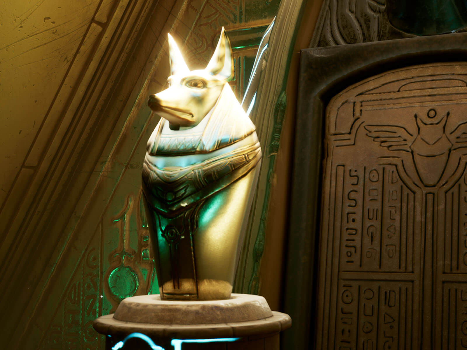 Golden canopic jar topped by an Anubis head.