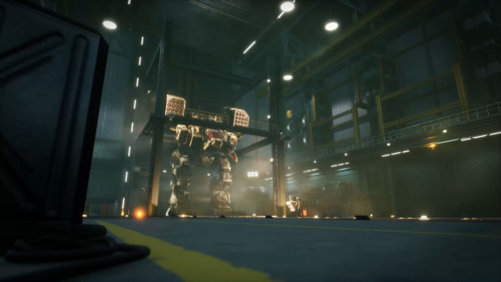 From a distance, a gigantic armored battle mech stands in a hangar.