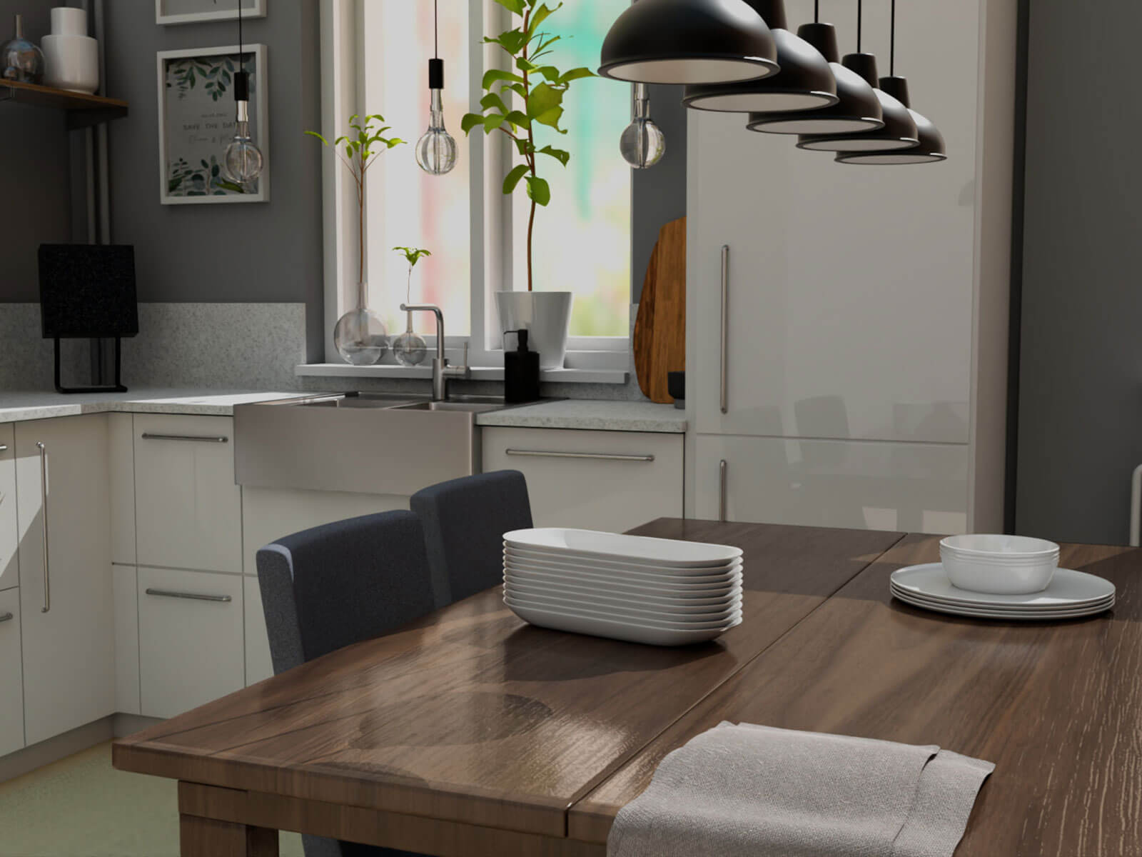 A simple kitchen with a table with plates stacked on top and counters and a sink in the background