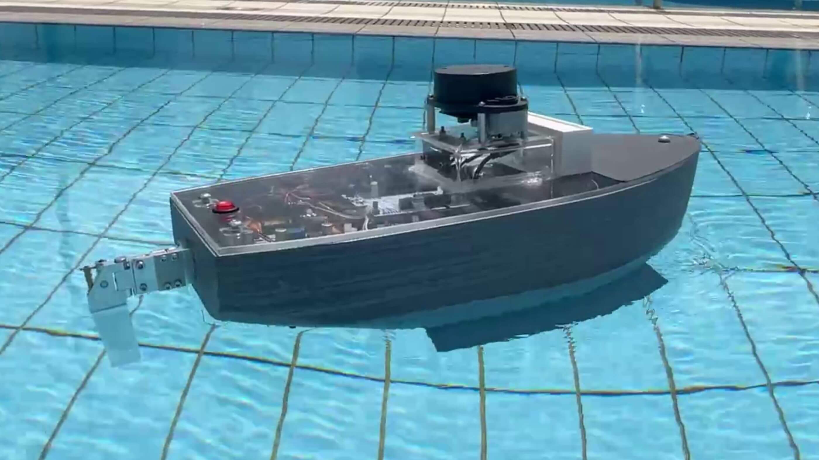 A student-created craft that resembles a boat floats in a pool