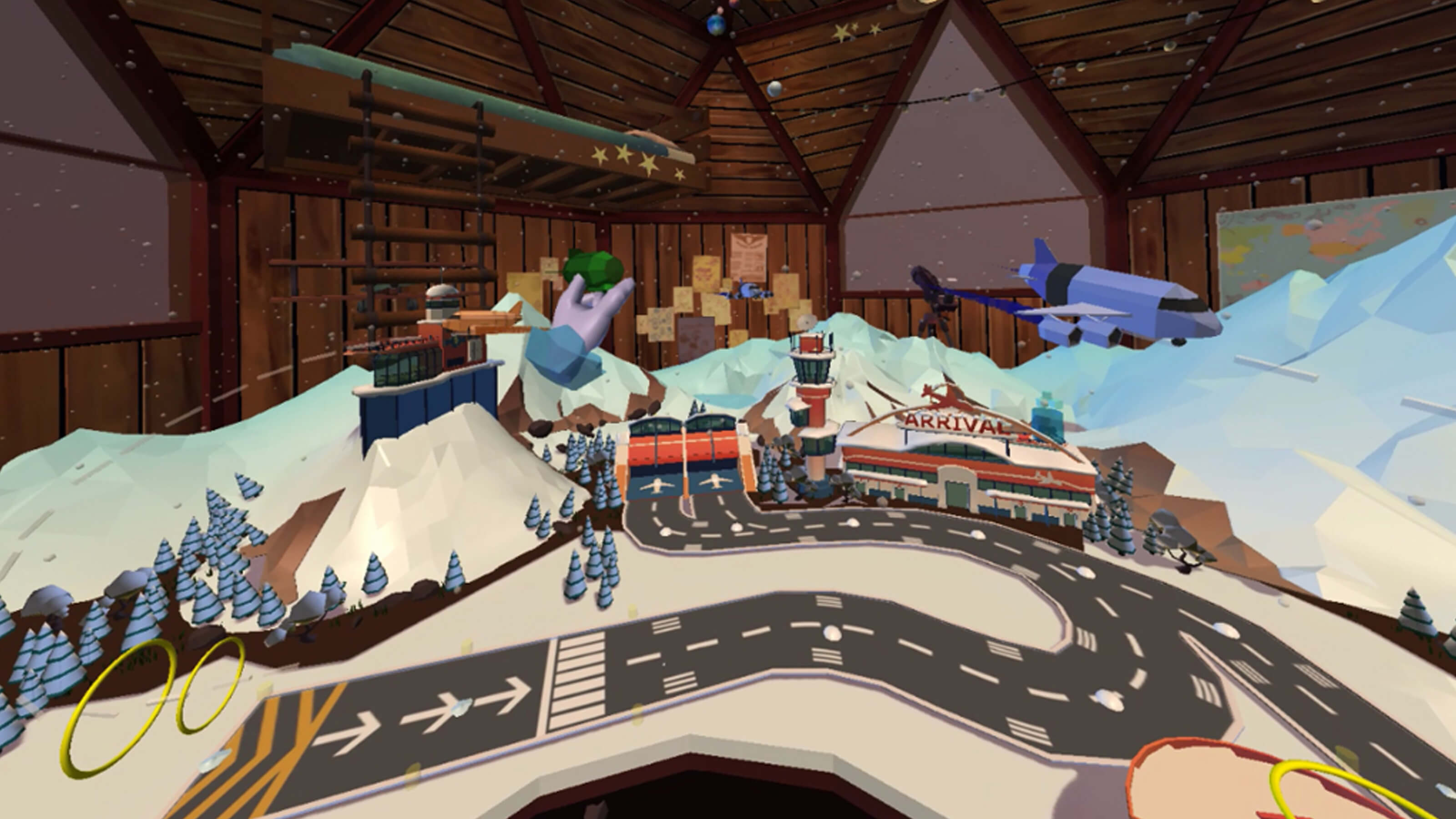 A snowy 3D modeled airport sit inside a wood-paneled room. The player's disembodied hand can be seen manipulating aircraft.