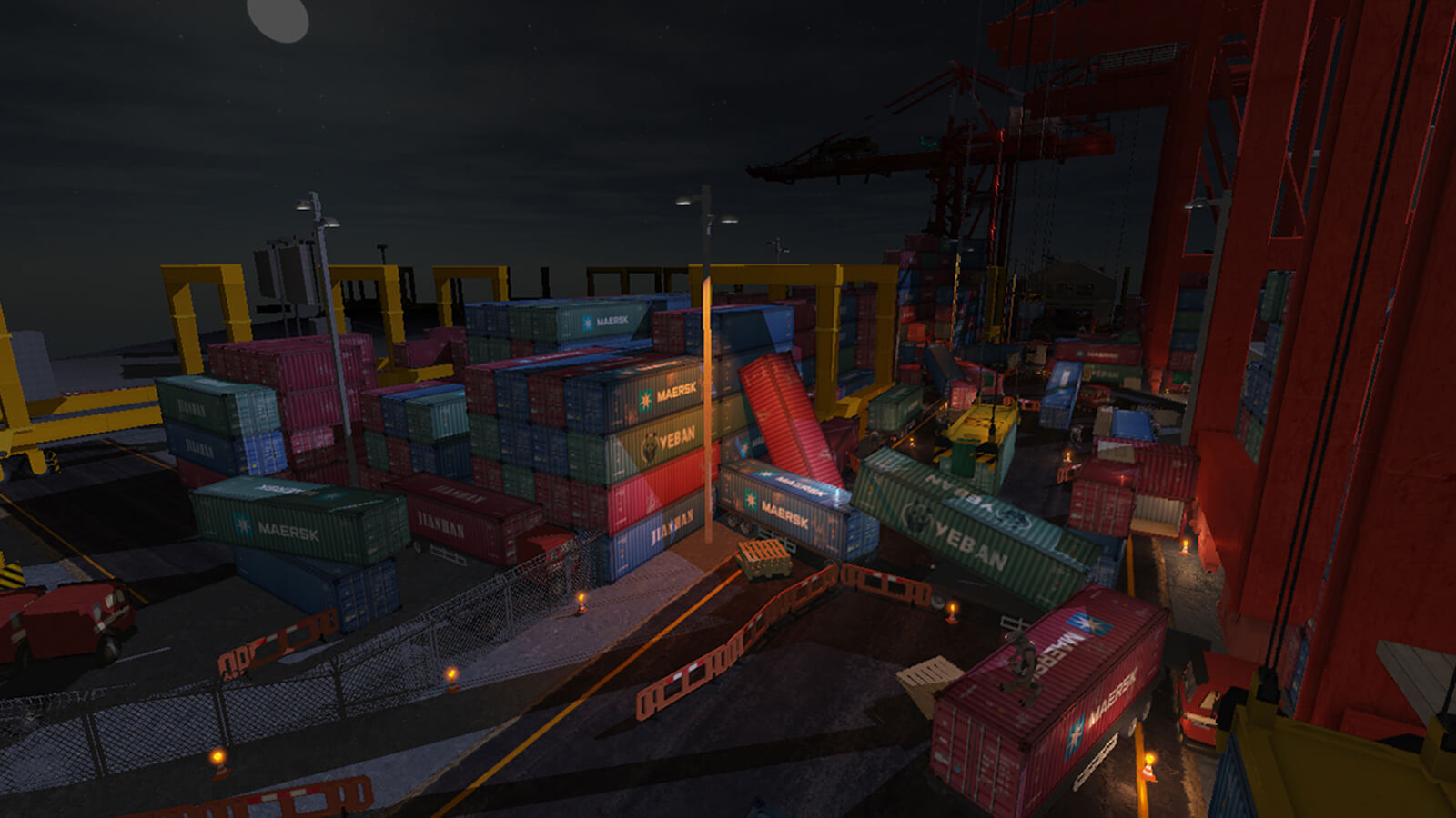 Dozens of shipping containers are stacked at a darkened dock. Several containers have fallen haphazardly to the ground.