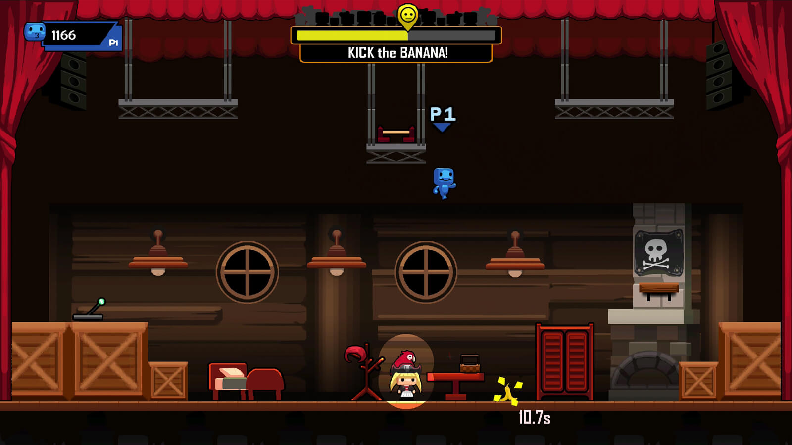 A blue player character leaps down onto a stage setting a pirate scene hoping to kick a banana