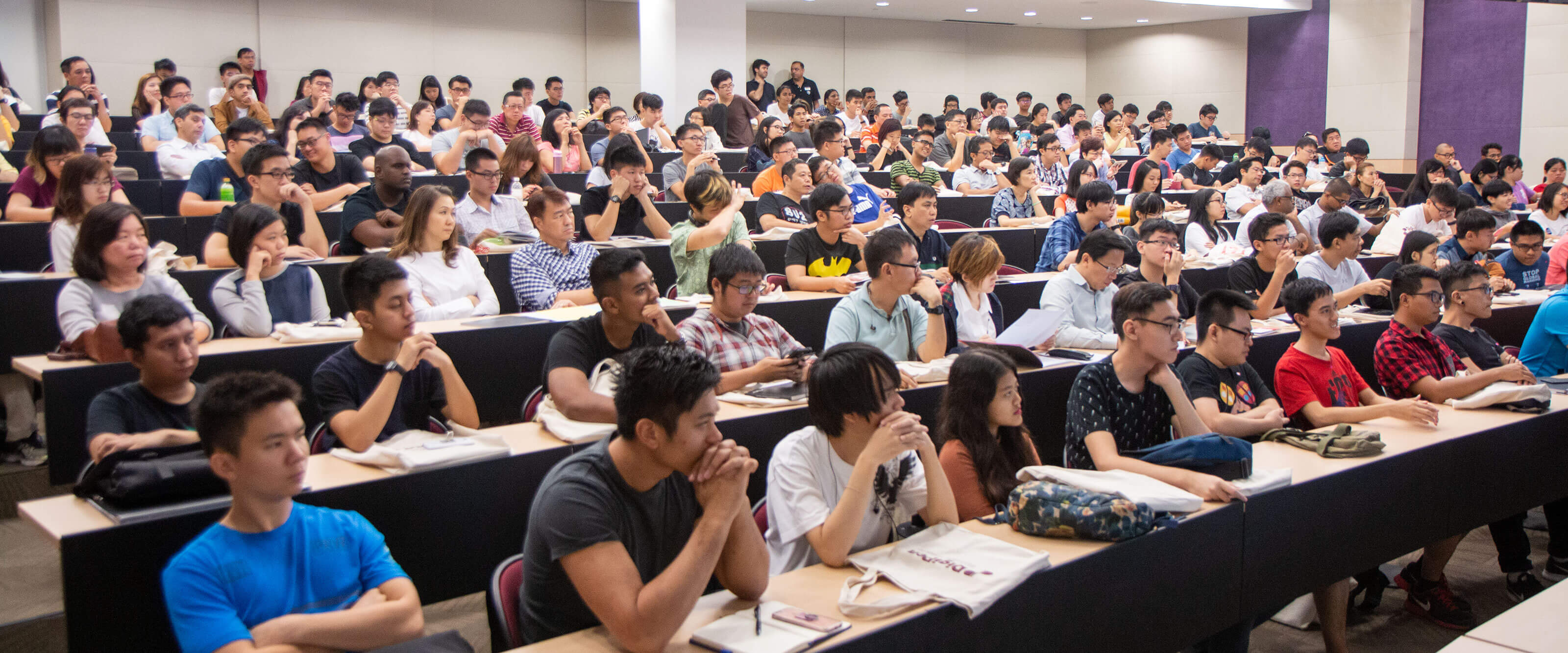 A packed auditorium full of seated students.