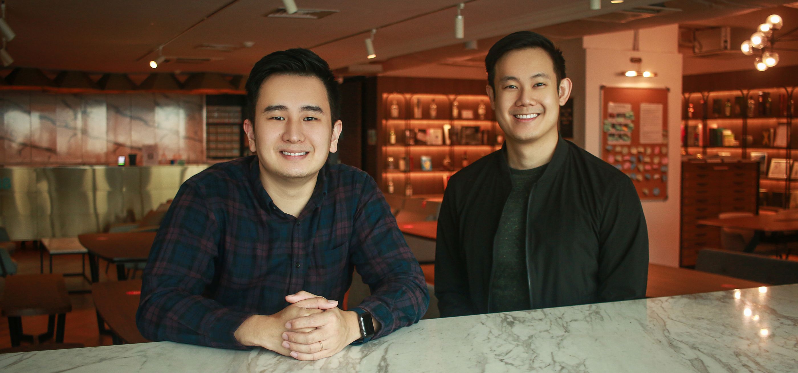 Datature co-founder Keechin Goh poses with another man.