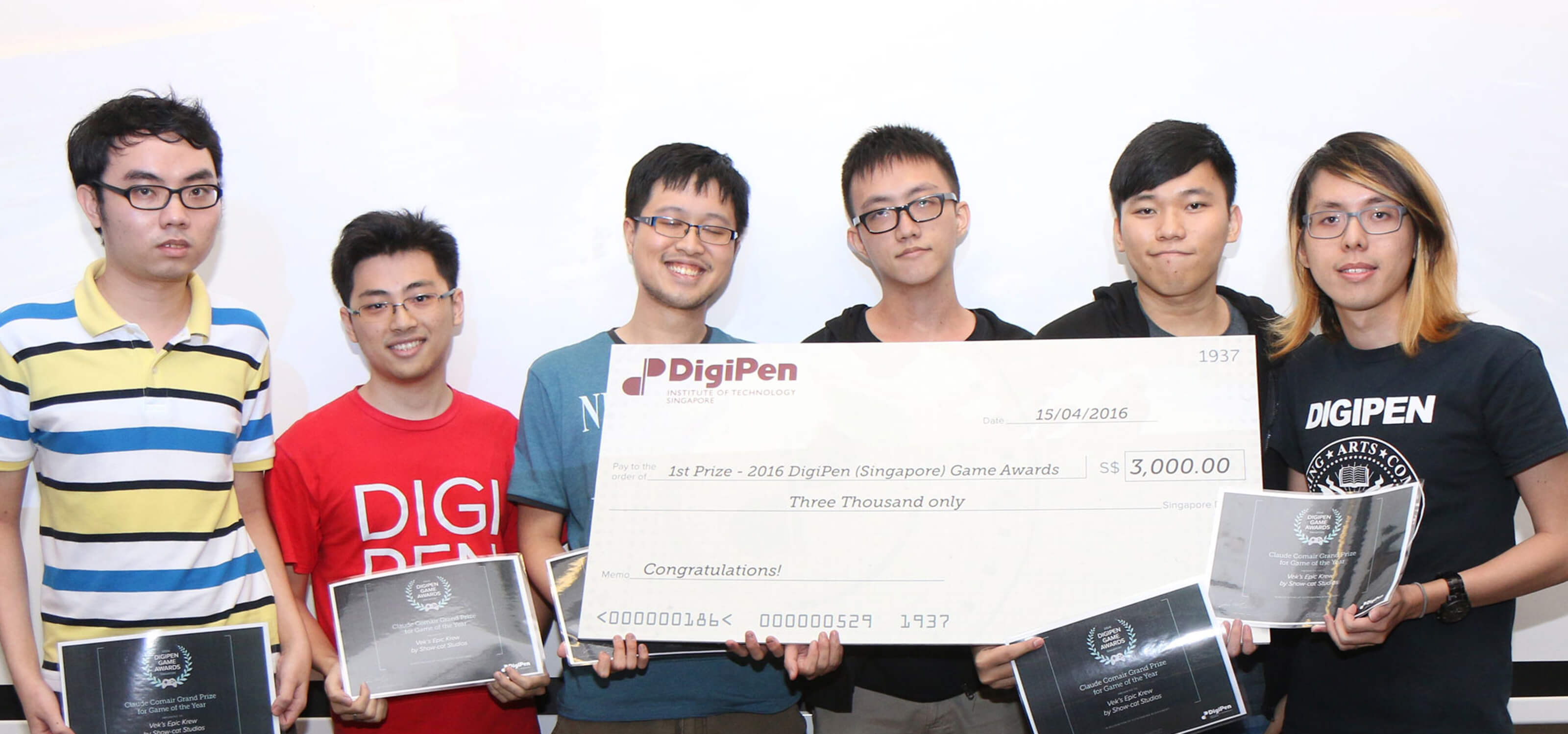 Students in the DigiPen (Singapore) Game Awards pose for a picture with certificates and a giant novelty check for $3000