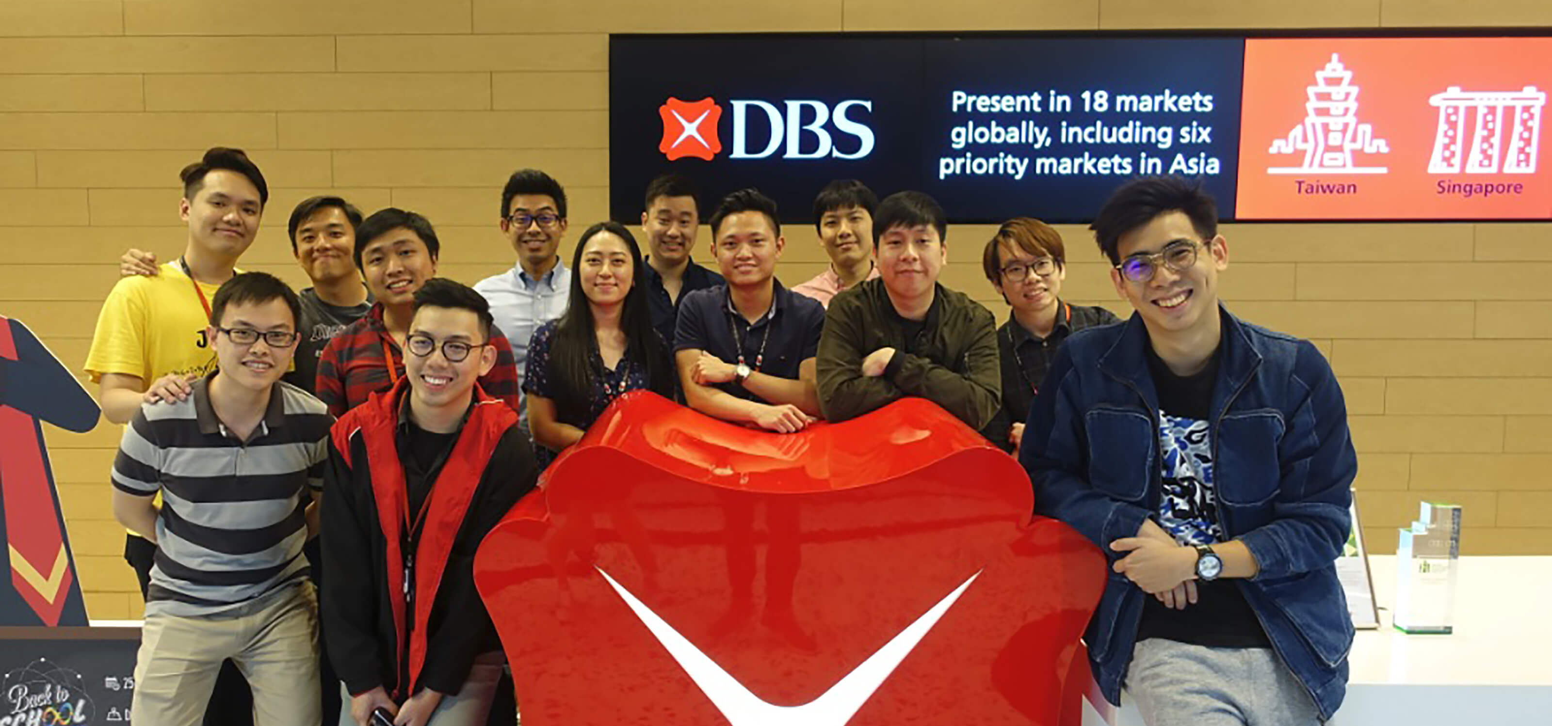 Group photo of 13 DigiPen (Singapore) alumni at DBS Bank