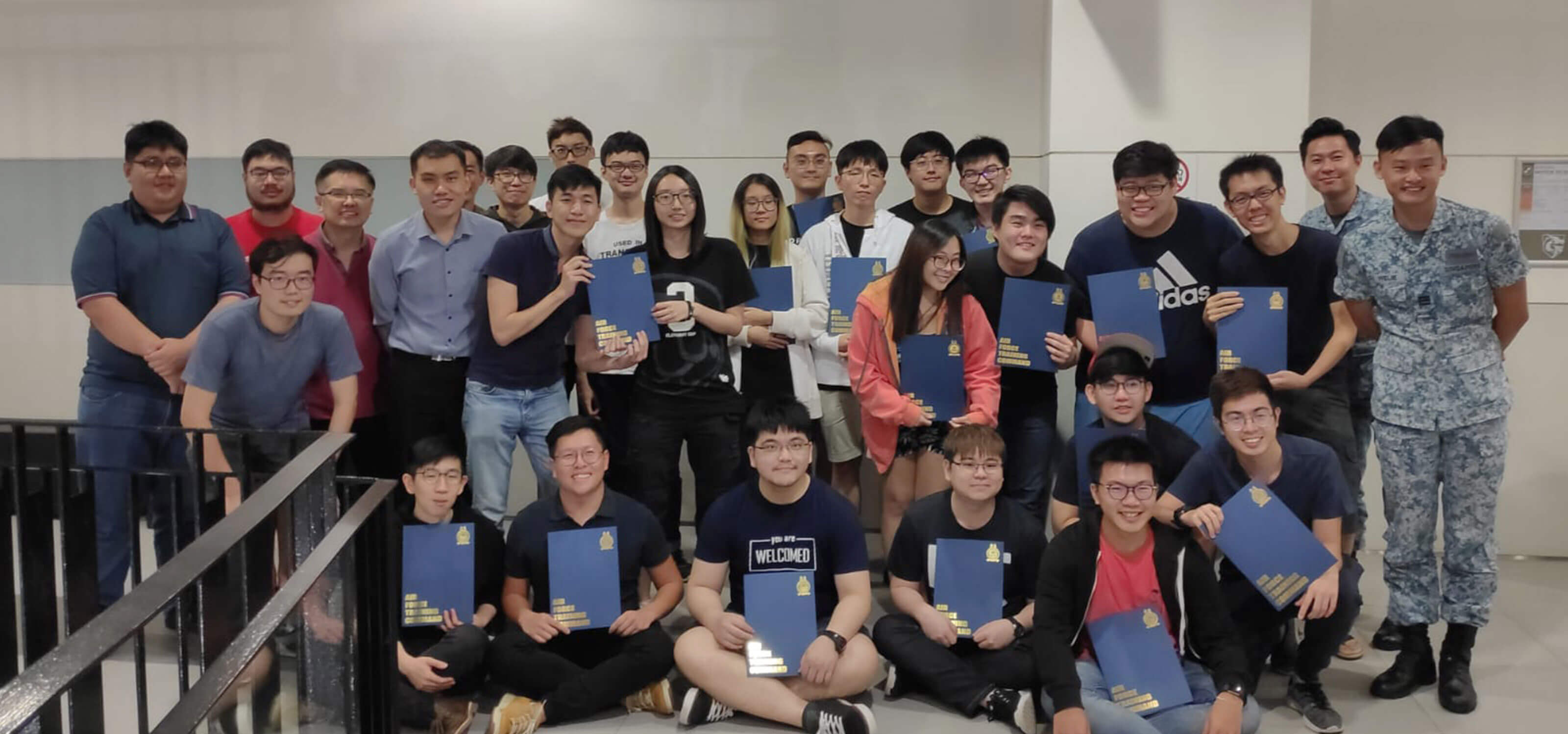 Group photo of 29 people, including DigiPen (Singapore) students and two instructors from the RSAF.