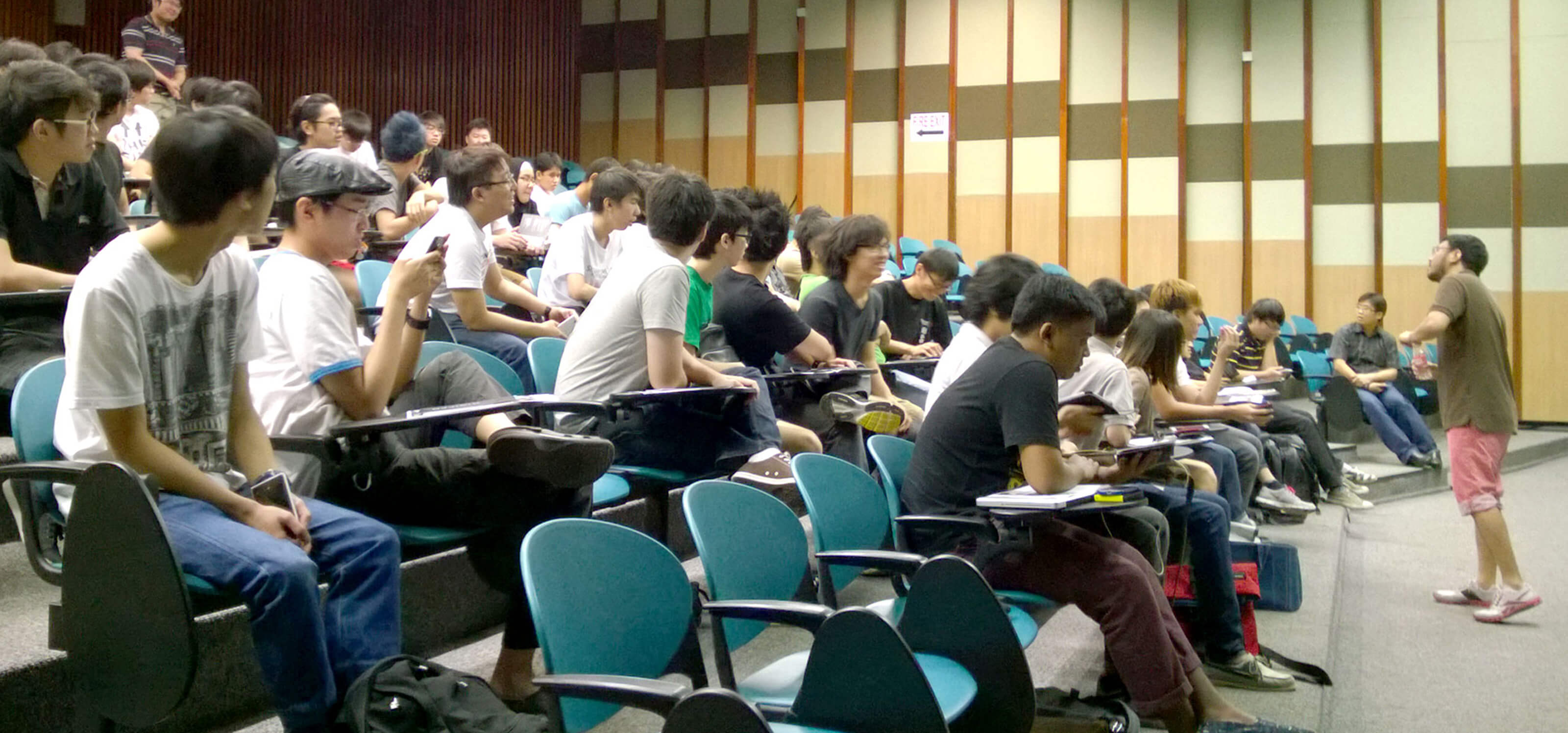 Dozens of polytechnic students attend a master class in an auditorium at DigiPen (Singapore)