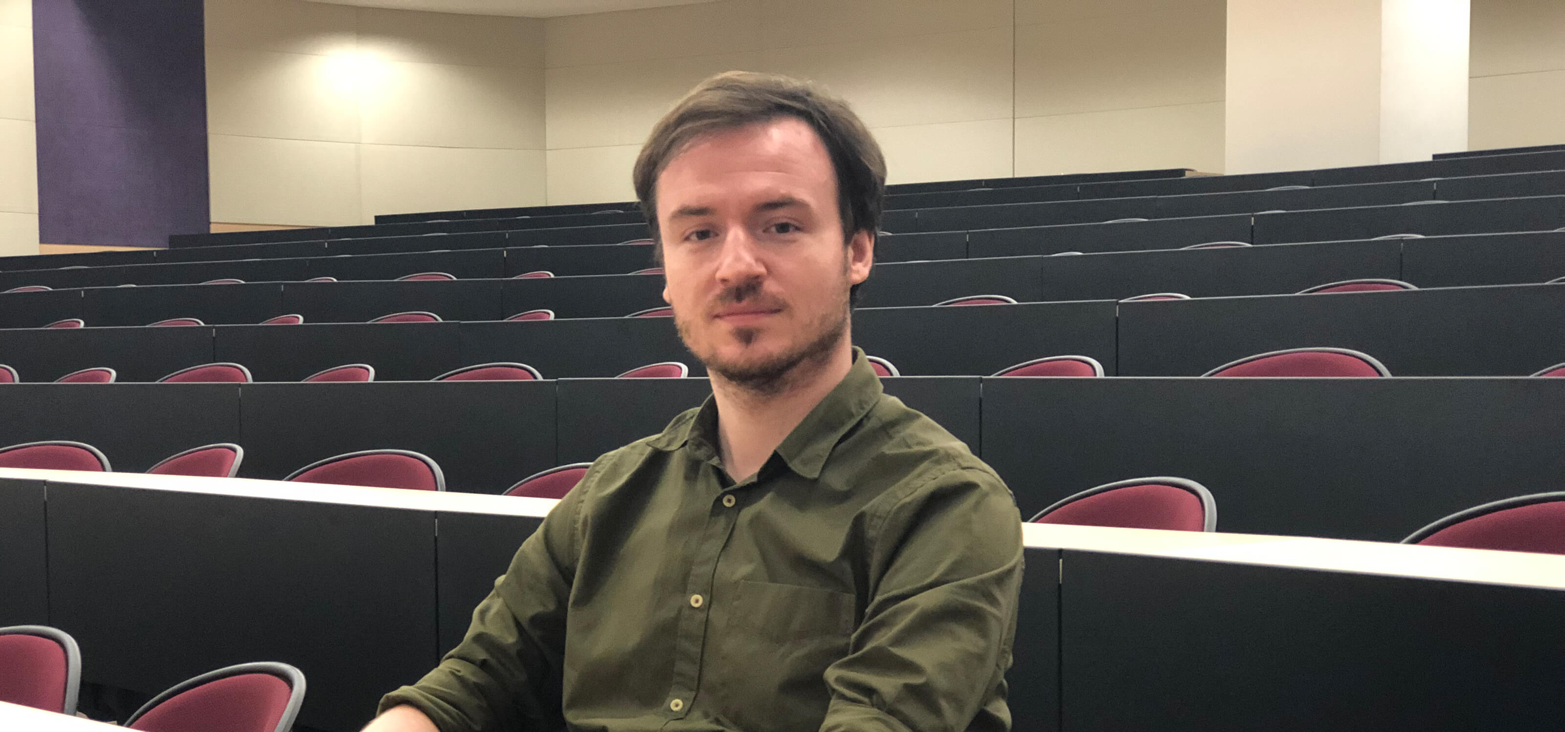 Slawomir "Swavek" Wlodkowski sits in an empty auditorium.