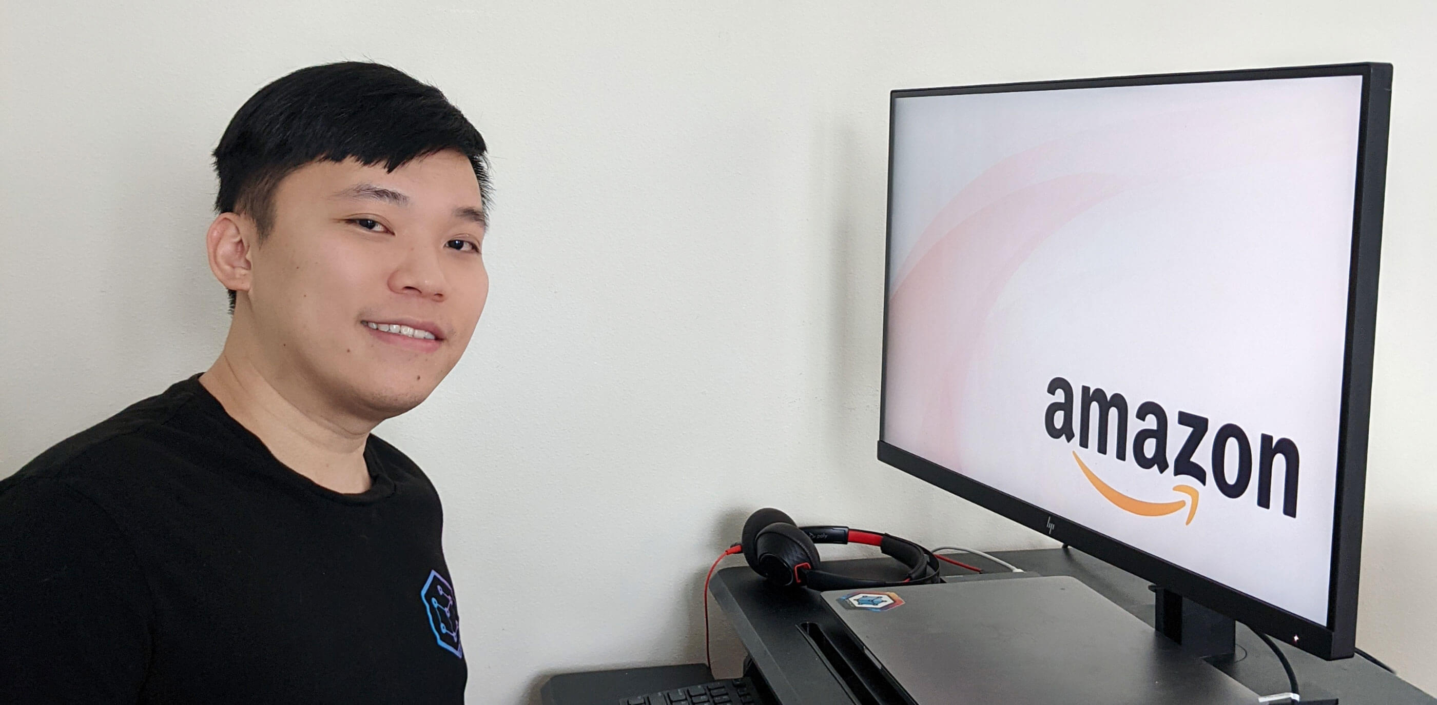DigiPen Singapore alumni Thin Big Zong sits in front of PC with Amazon logo onscreen