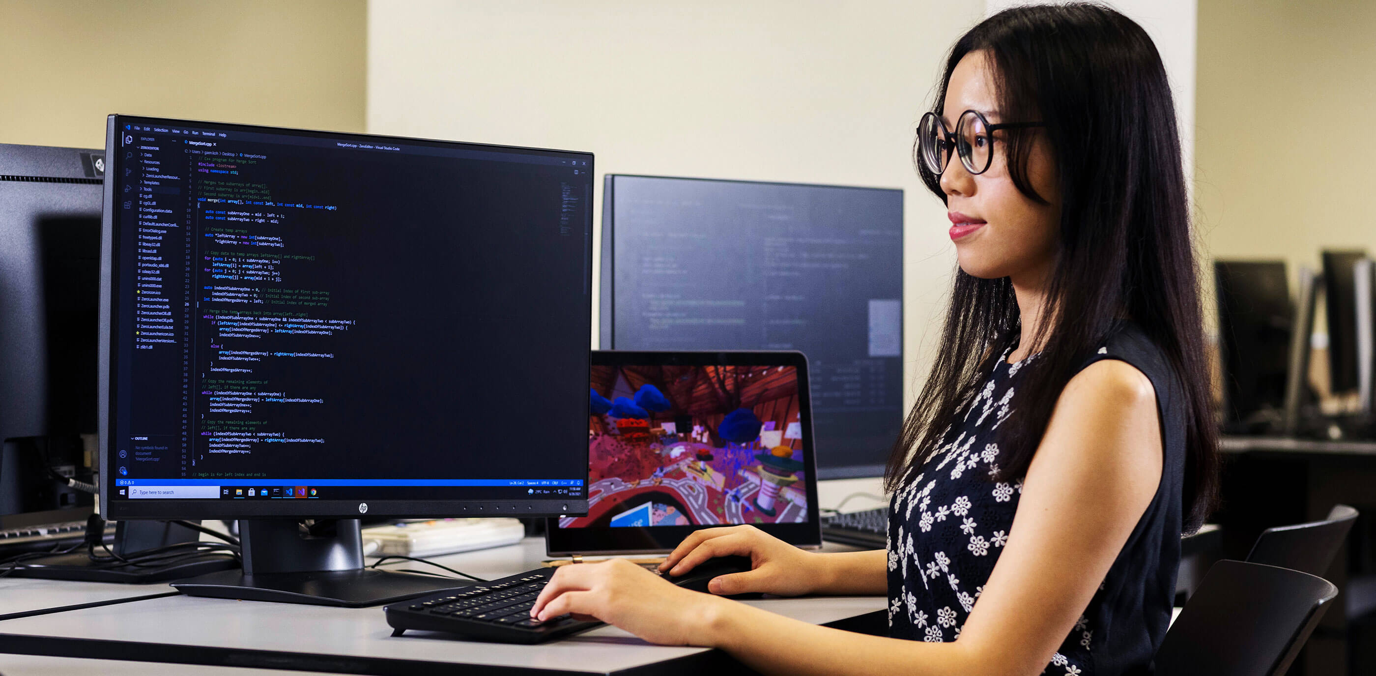 Student sitting at desk working at computer.