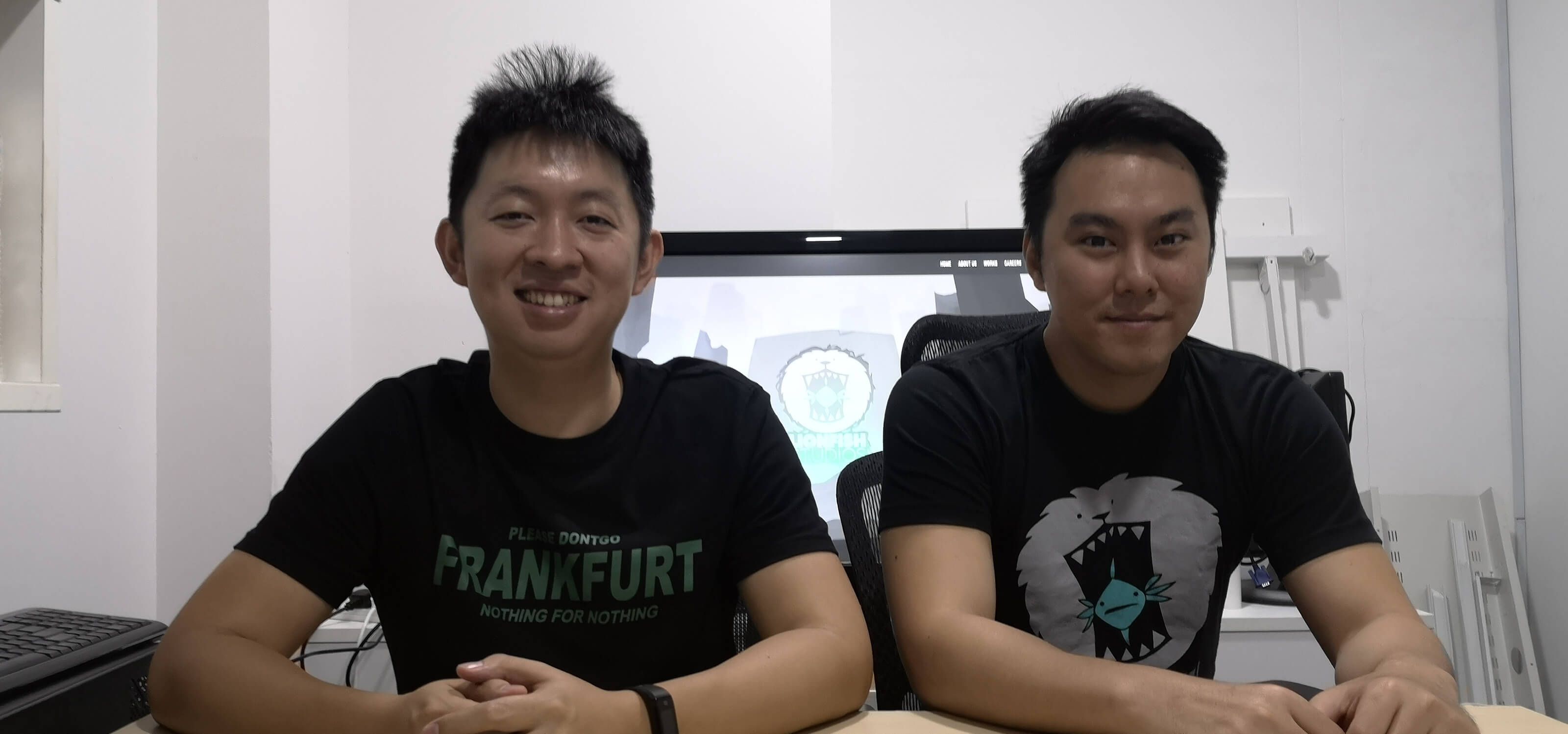 DigiPen (Singapore) alumni Zhang Zi Tian and Koh Shi Xiang sit in the office of Lionfish Studios, which they co-founded