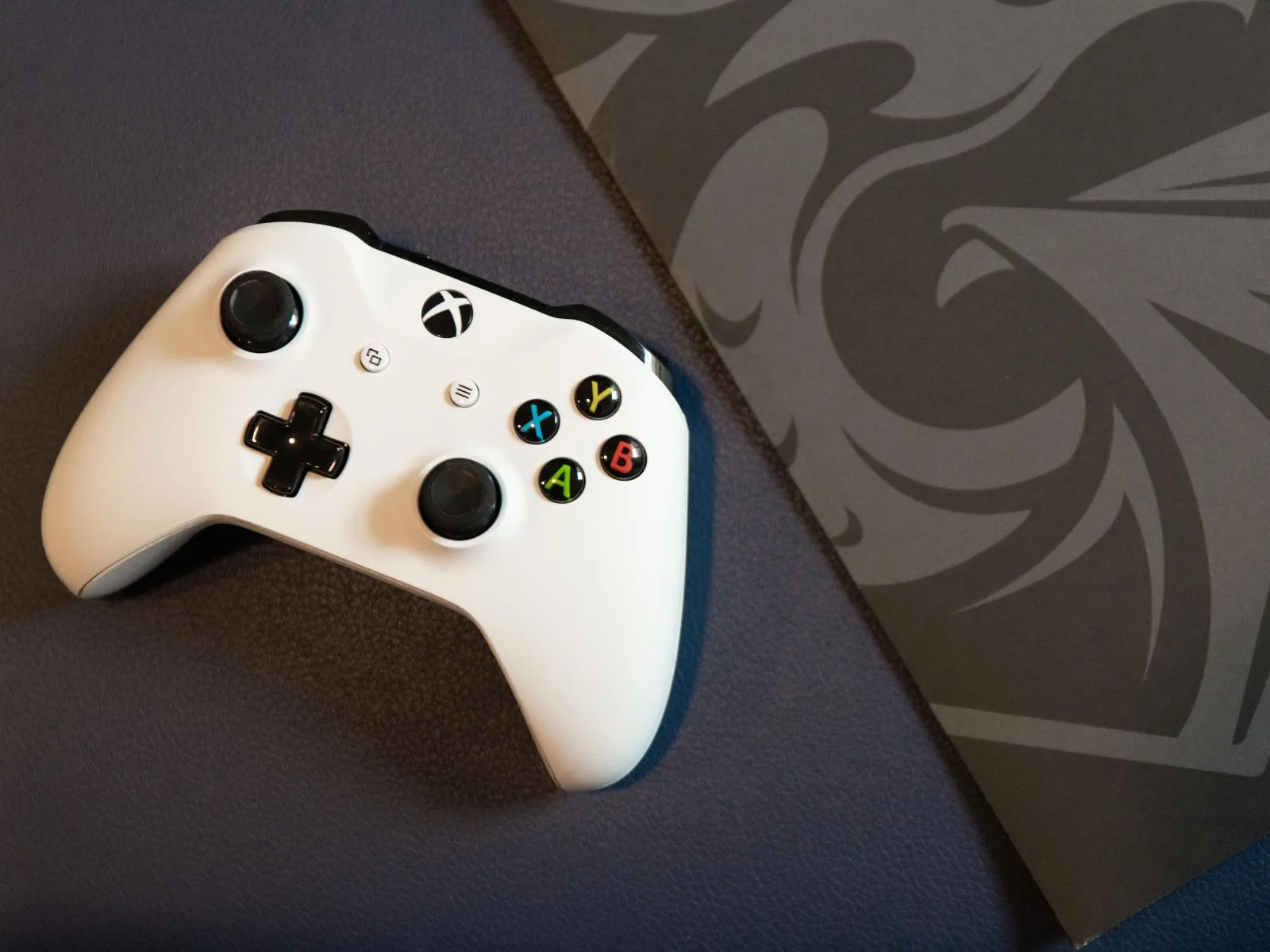 Xbox controller next to a DigiPen folder.