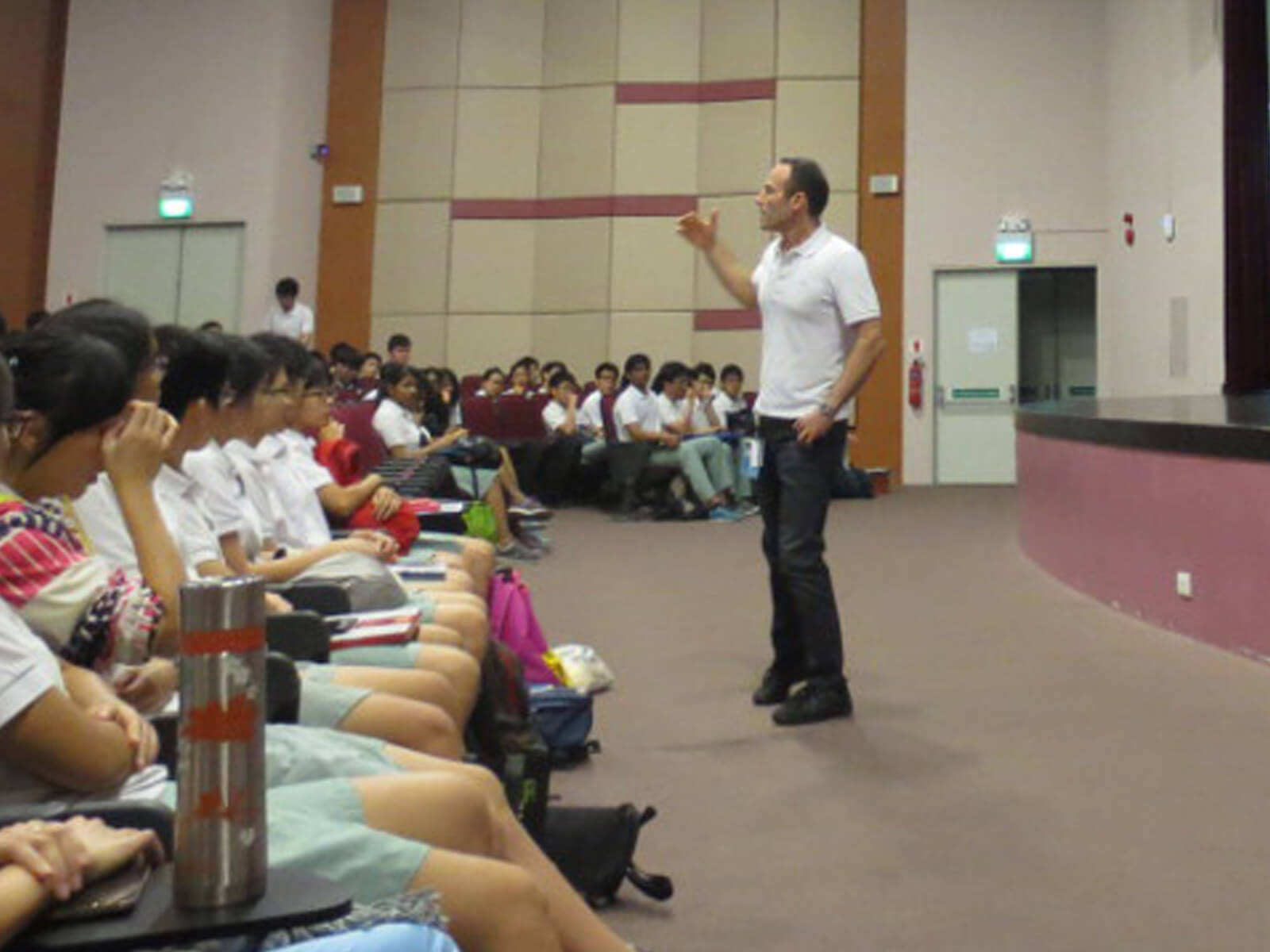 DigiPen CTO Samir Abou Samra speaks to students in a large presentation hall