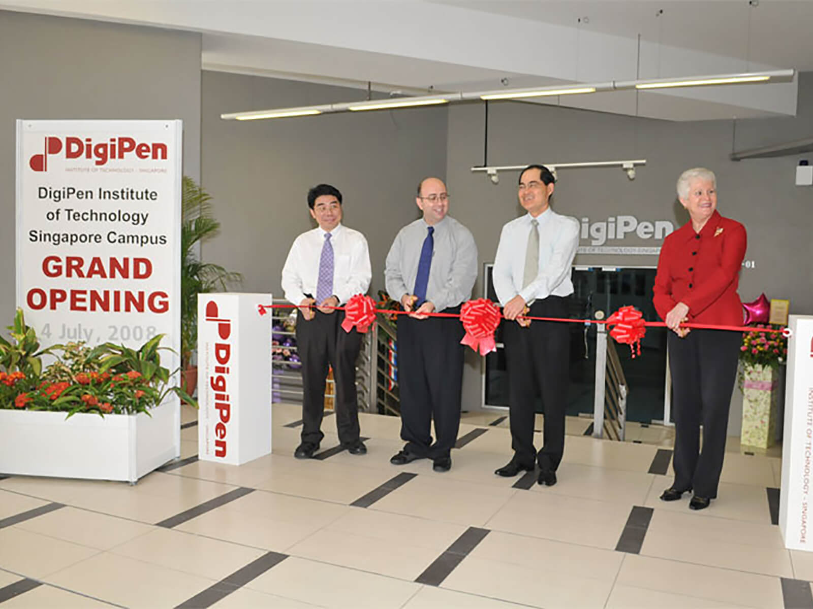 DigiPen COO Jason Chu and Founder Claude Comair cut the ribbon at the new DigiPen (Singapore) campus in 2008