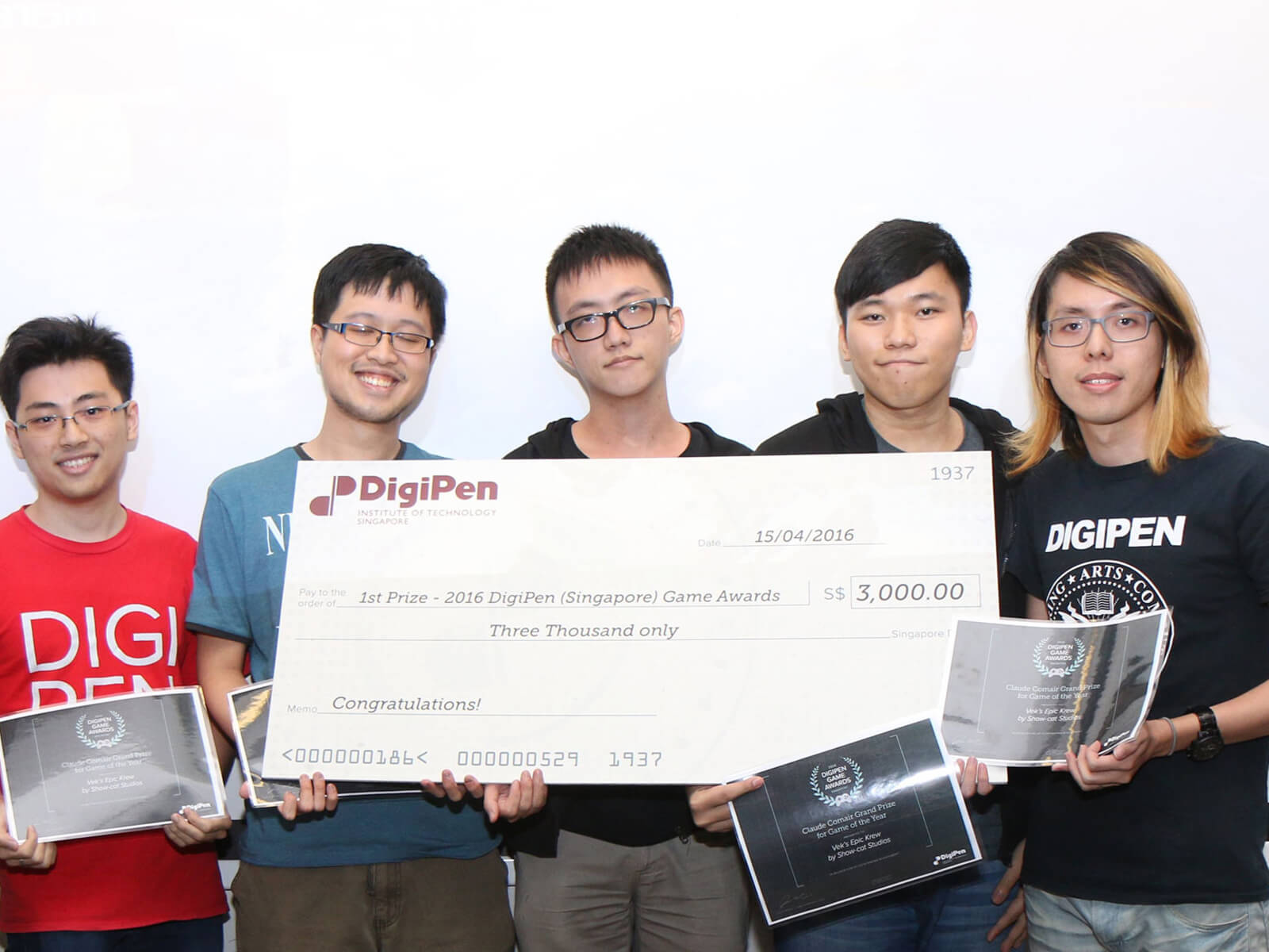 Students in the DigiPen (Singapore) Game Awards pose for a picture with certificates and a giant novelty check for $3000