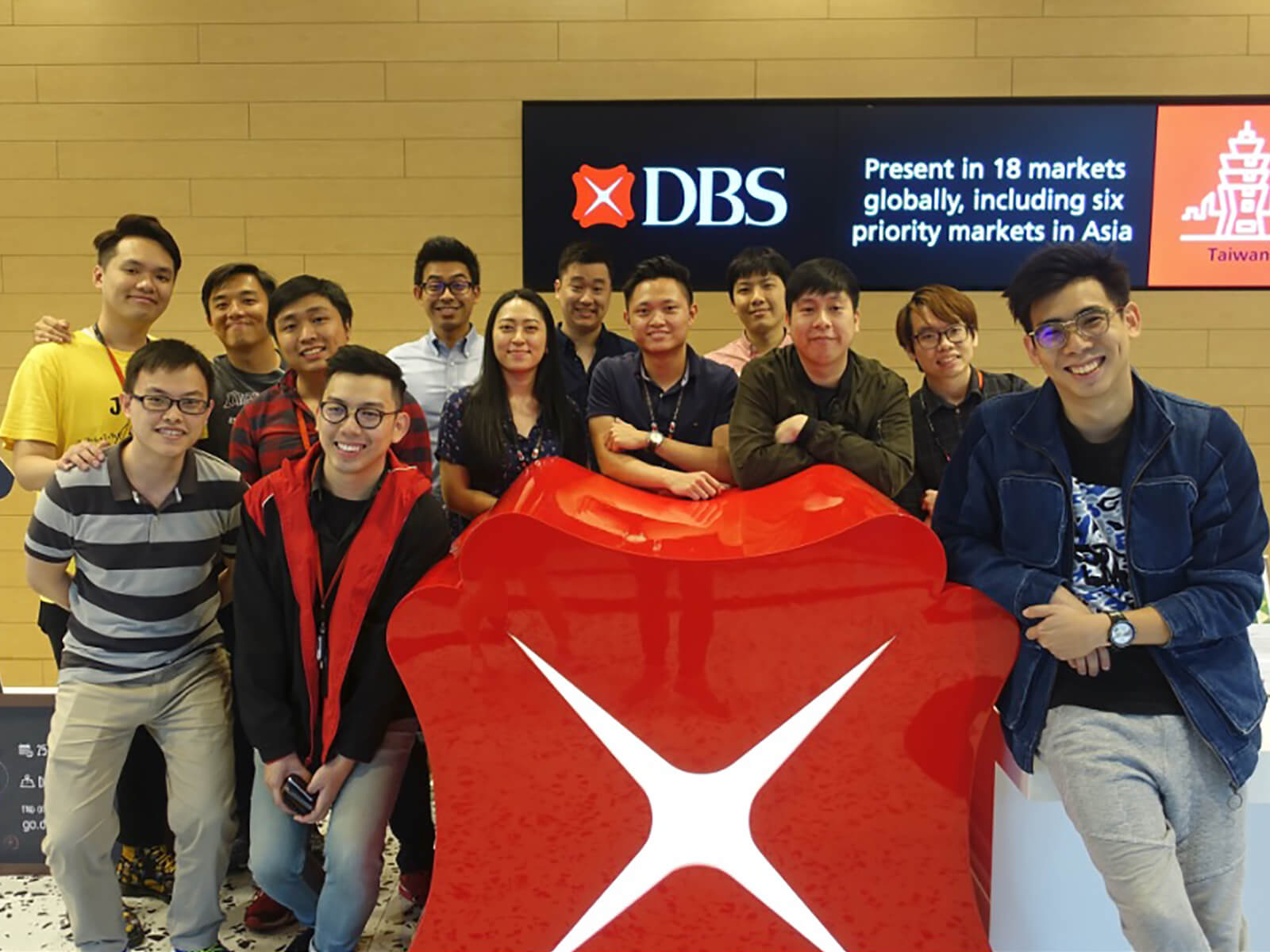 Group photo of 13 DigiPen (Singapore) alumni at DBS Bank