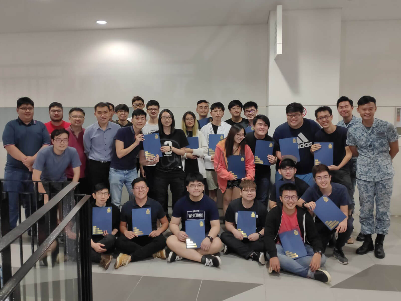 Group photo of 29 people, including DigiPen (Singapore) students and two instructors from the RSAF.