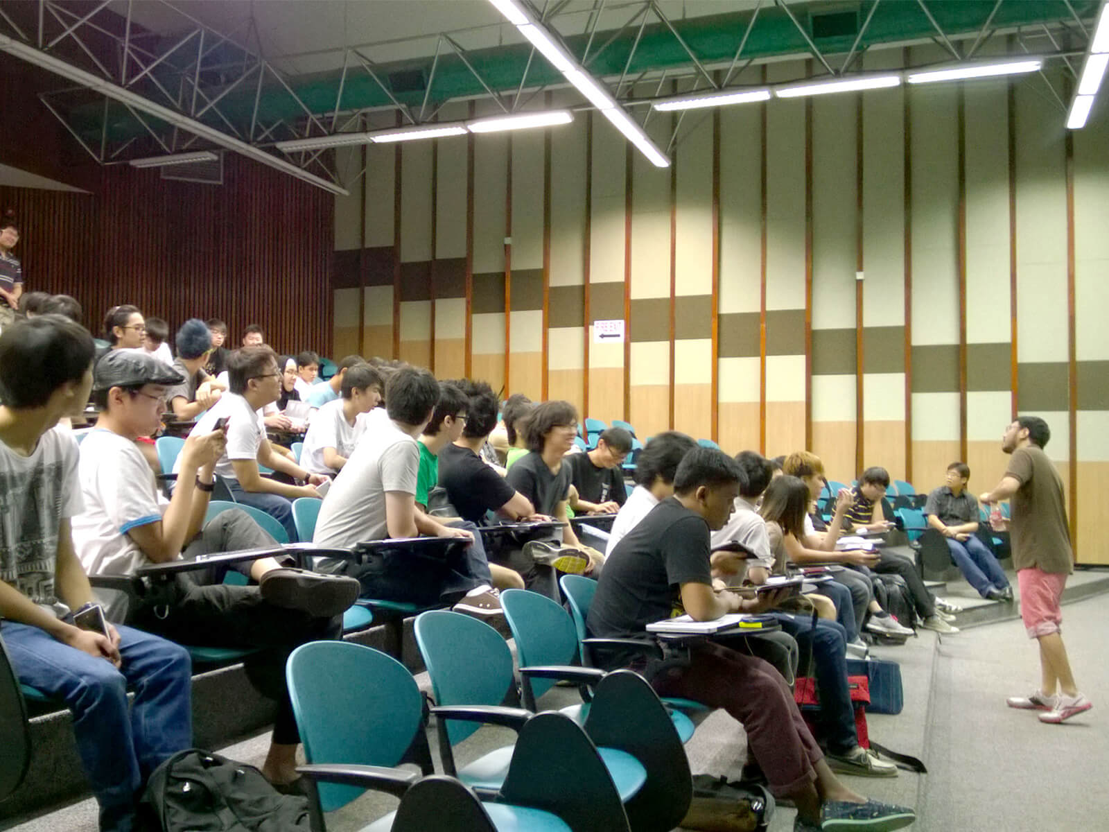 Dozens of polytechnic students attend a master class in an auditorium at DigiPen (Singapore)