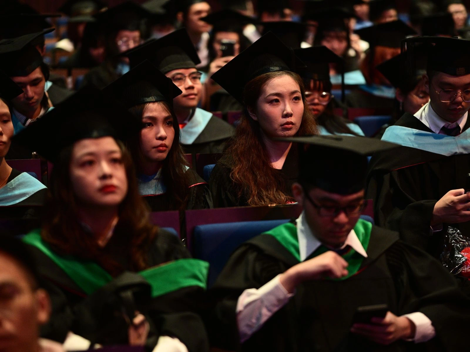 Students sit at a graduation ceremony.