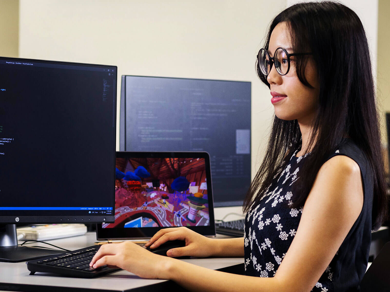 Student sitting at desk working at computer.