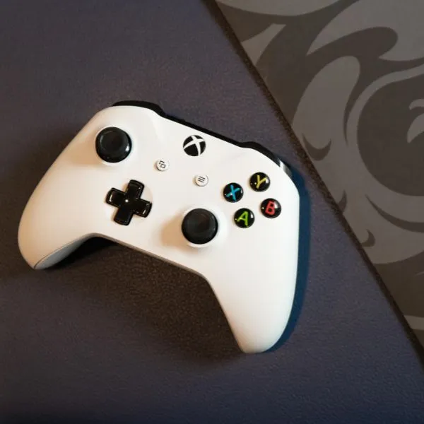 Xbox controller next to a DigiPen folder.