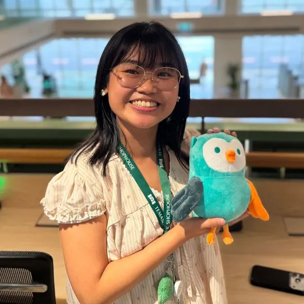 Sandy Kee holding a plush stuffed animal.