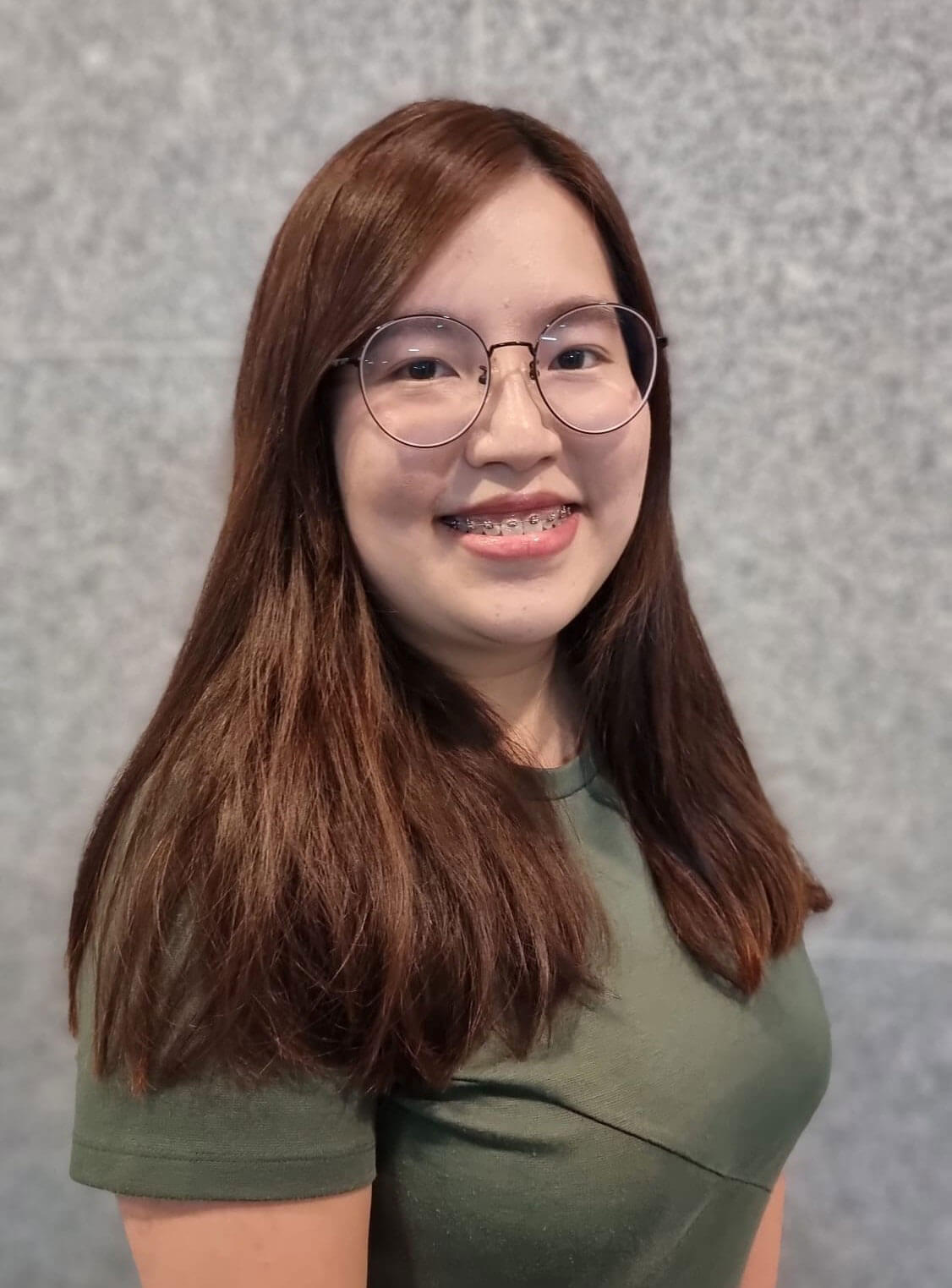 Carmen Chan wearing glasses and smiling at the camera