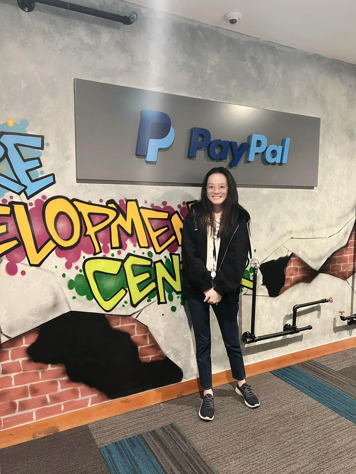 DigiPen Singapore Alumna Jobelle Lim standing near the PayPal sign
