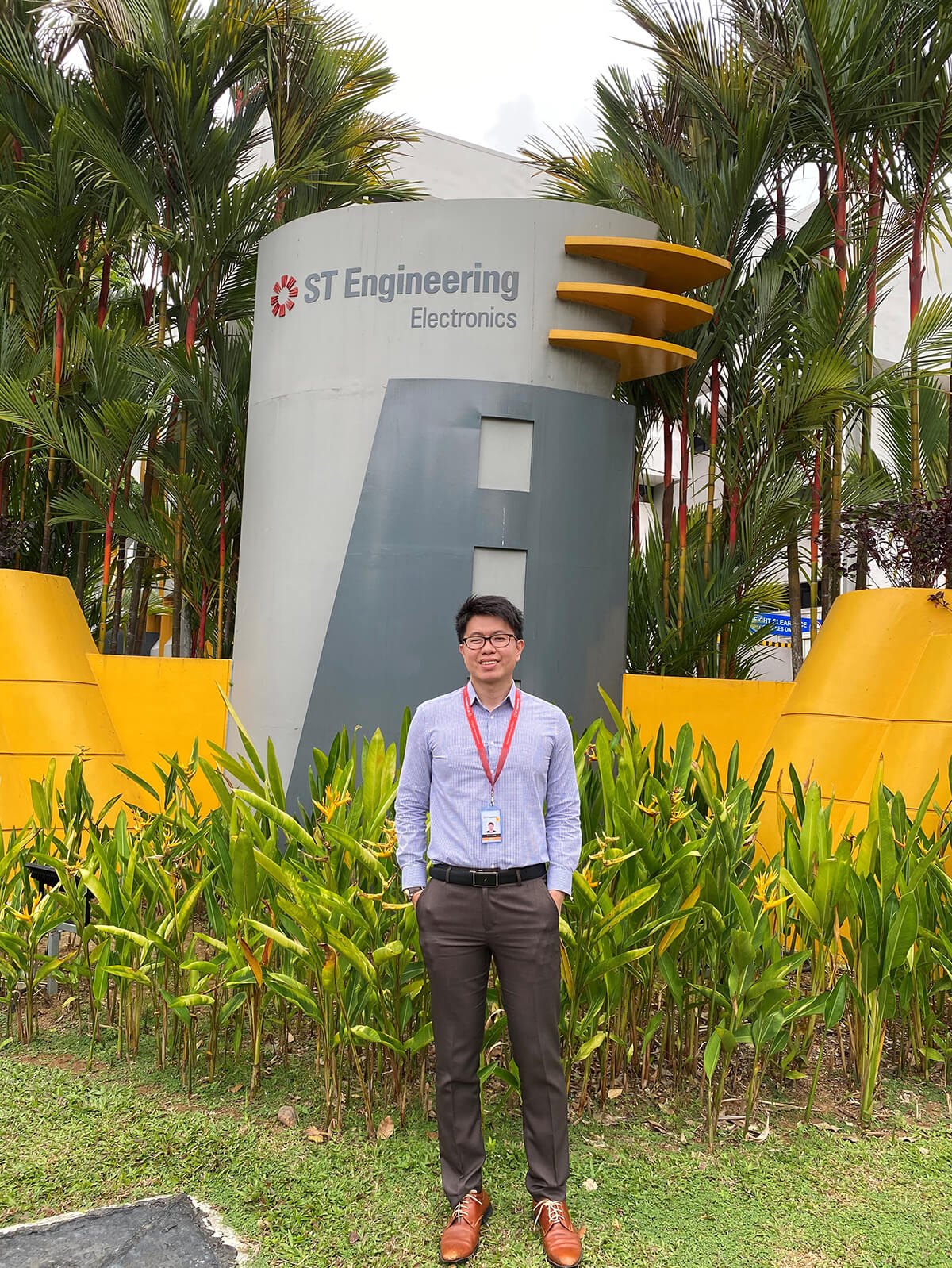 Alvin Lui stands outside the ST Engineering building.