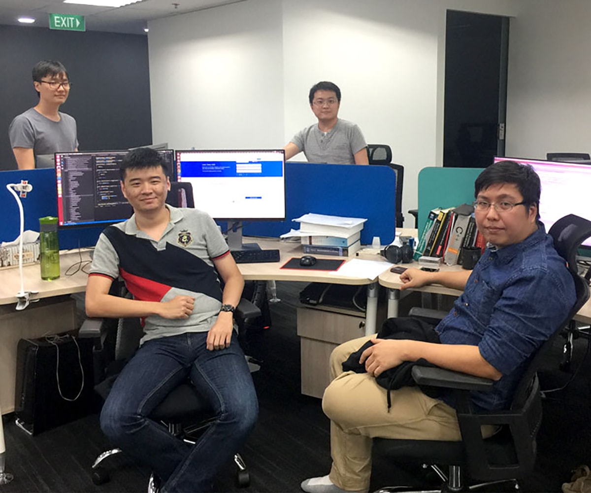 DigiPen Singapore alumni at their desks in the NetVirta office