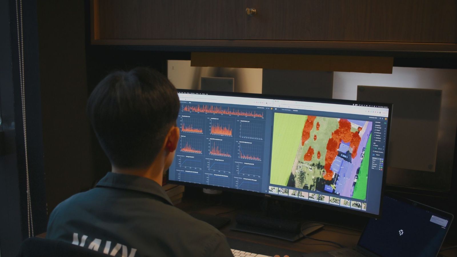 Man sits behind a desktop computer with two screens