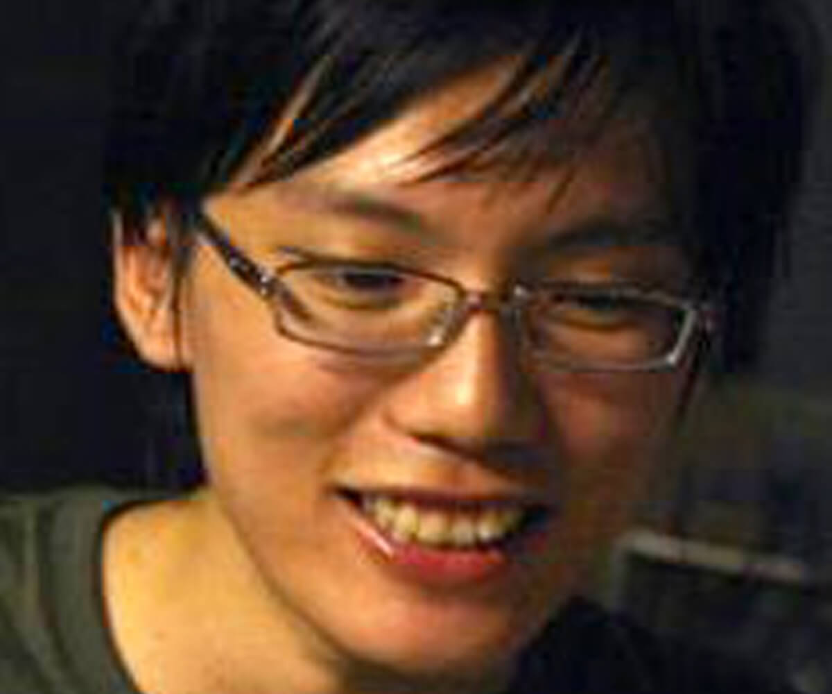 Headshot of alumnus Desmond Wong in glasses, looking down