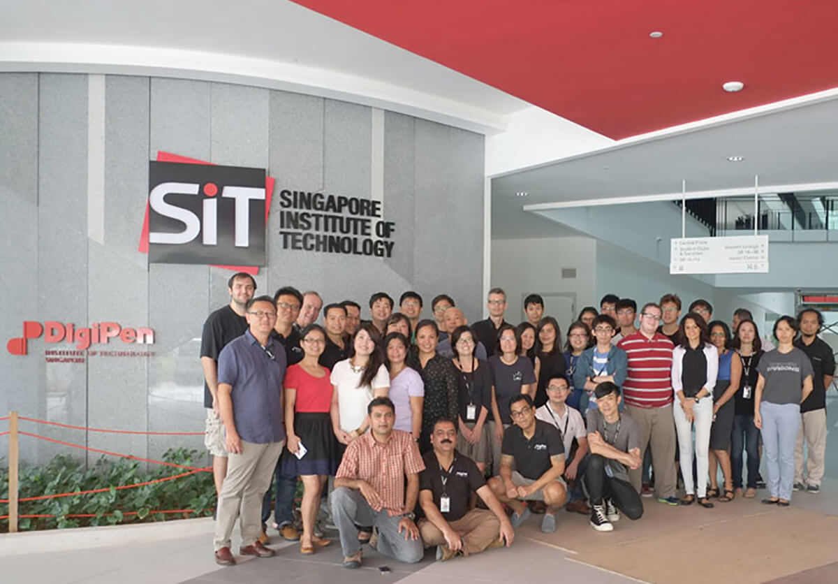 DigiPen (Singapore) staff members pose in the lobby of the new campus building