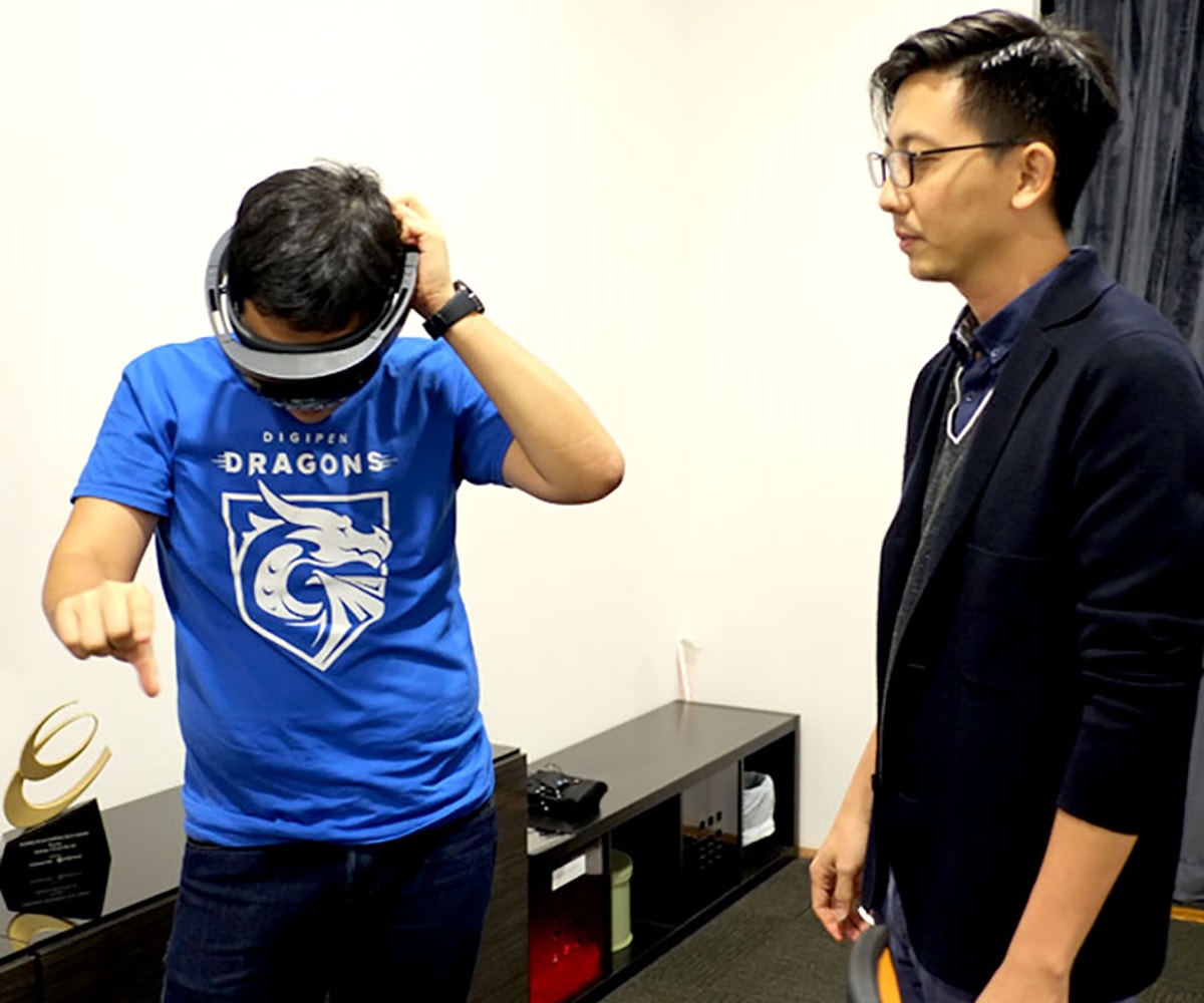 Two DigiPen (Singapore) alumni experiment with a virtual reality headset