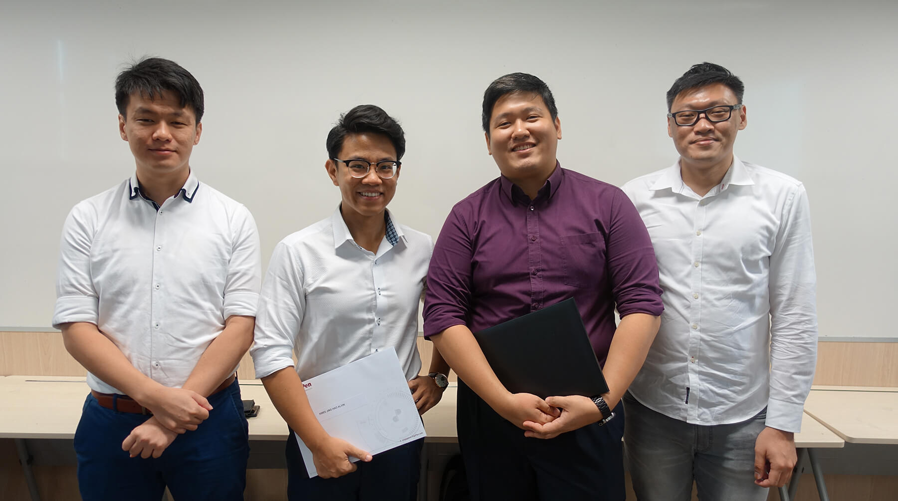 Four CE program graduates, Tan Ken Yang, Alvin Kwee, Yap Yuanzhen, and Ian Tan, line up for a group photo.
