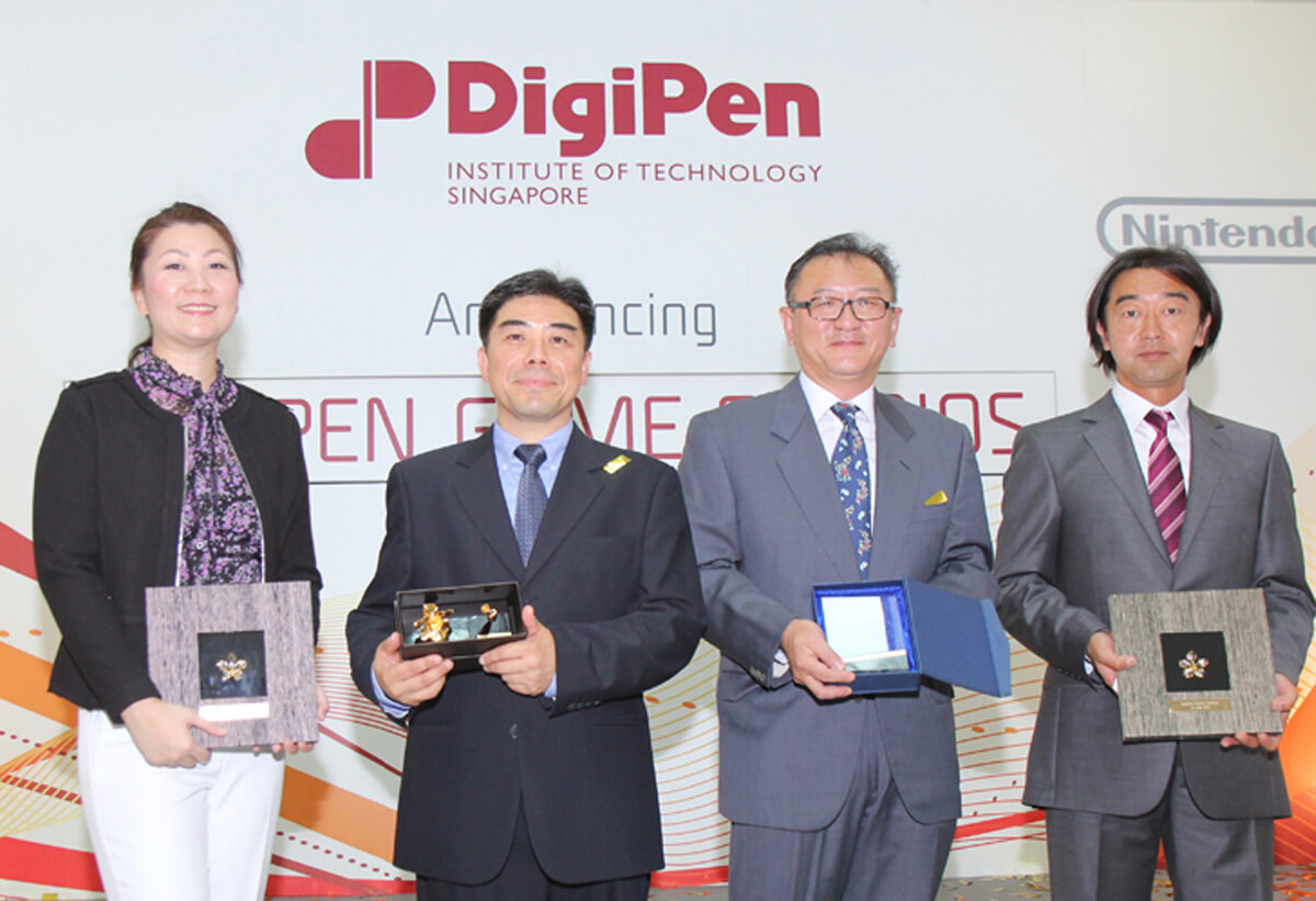 DigiPen Game Studios executives pose for a picture with plaques and awards