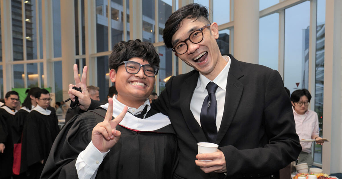 DigiPen faculty member Dominic Chang poses for a photo with another person