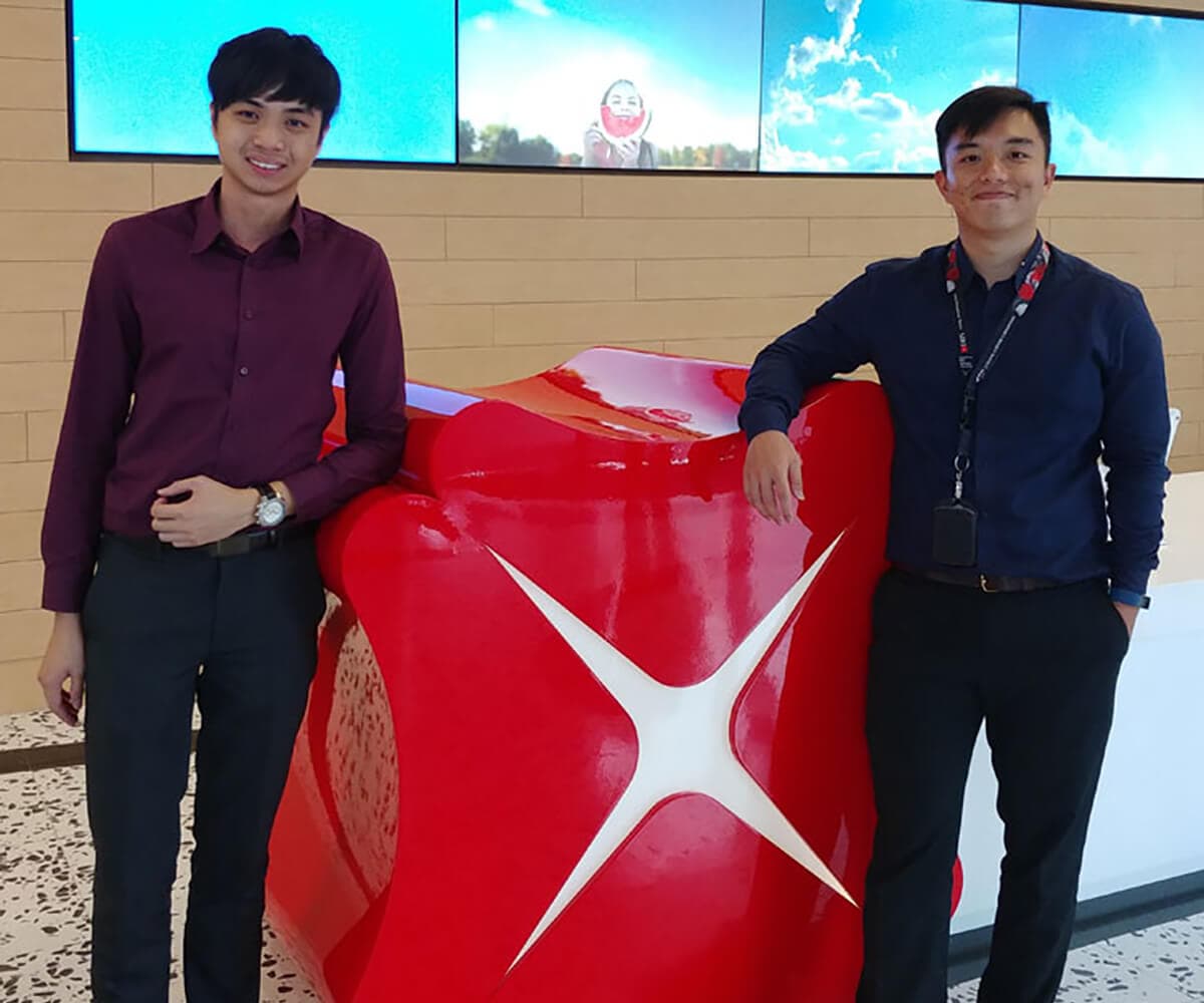 DigiPen Singapore alumni izaak Foong and Farris Chua pose in DBS Bank lobby