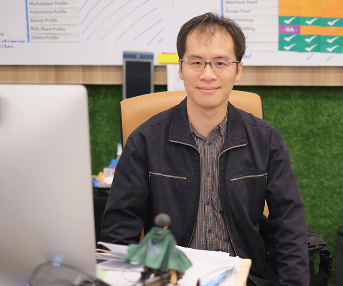 Graduate Lam Chun On sits at a desk in front of a computer