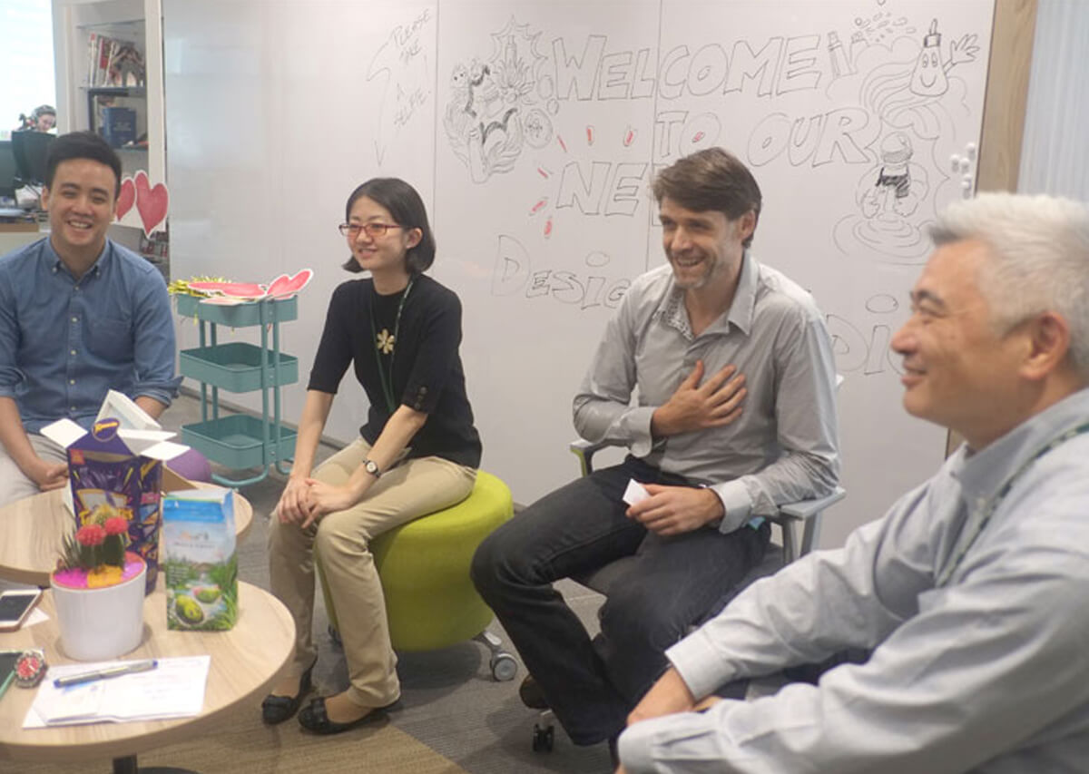 Graduate Larry Low Yun Long sits with members of the Proctor & Gamble team