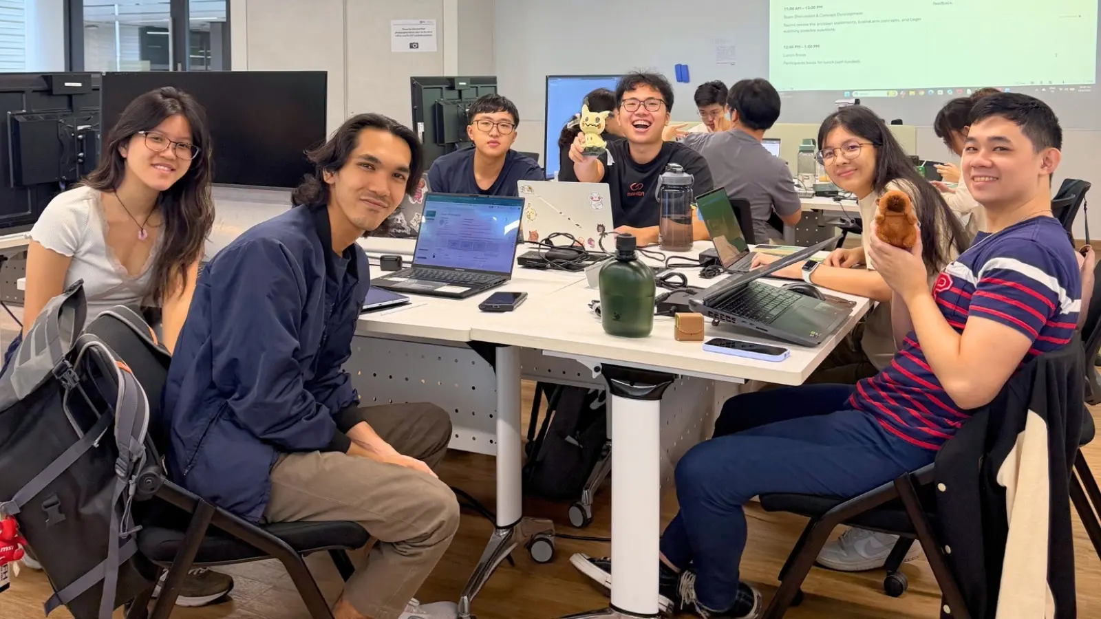 Hackathon participants sit around a table.