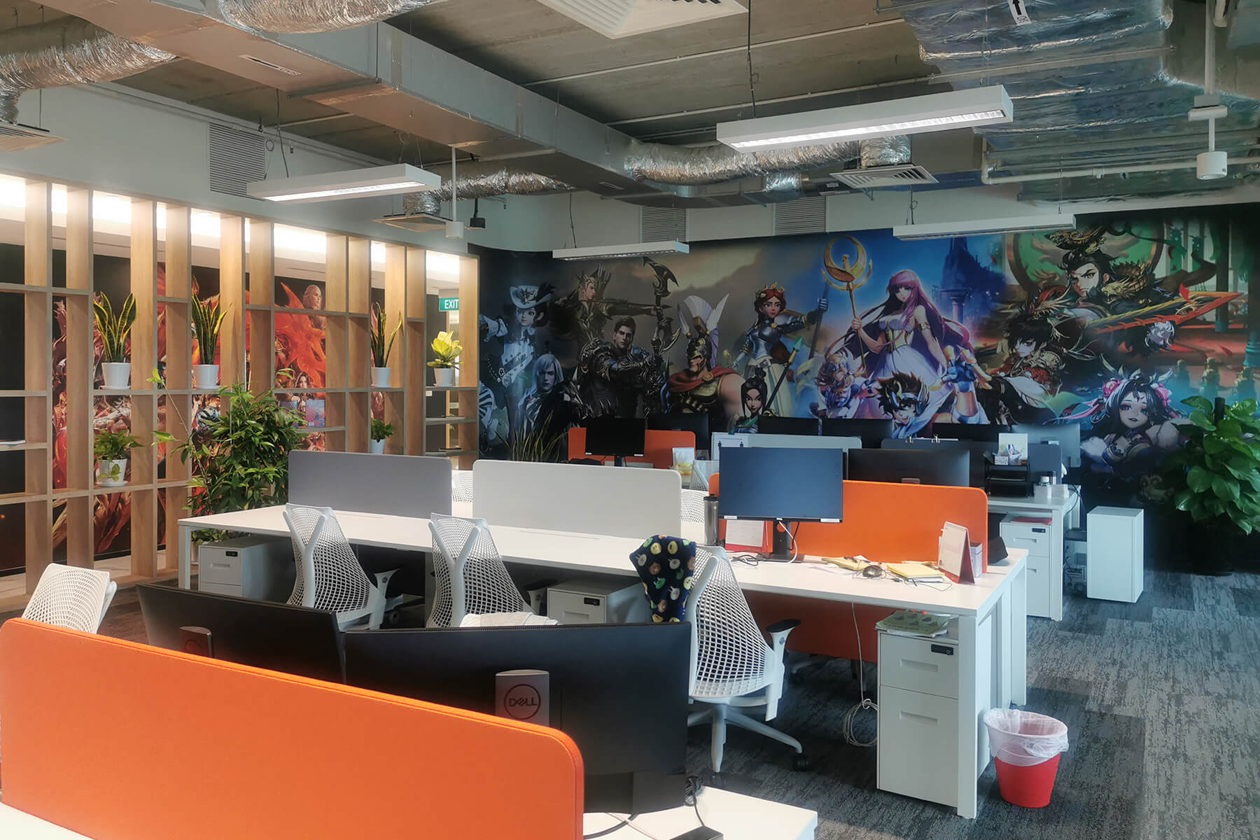 Picture of the Yoozo Games work area, featuring a colorful mural of game characters