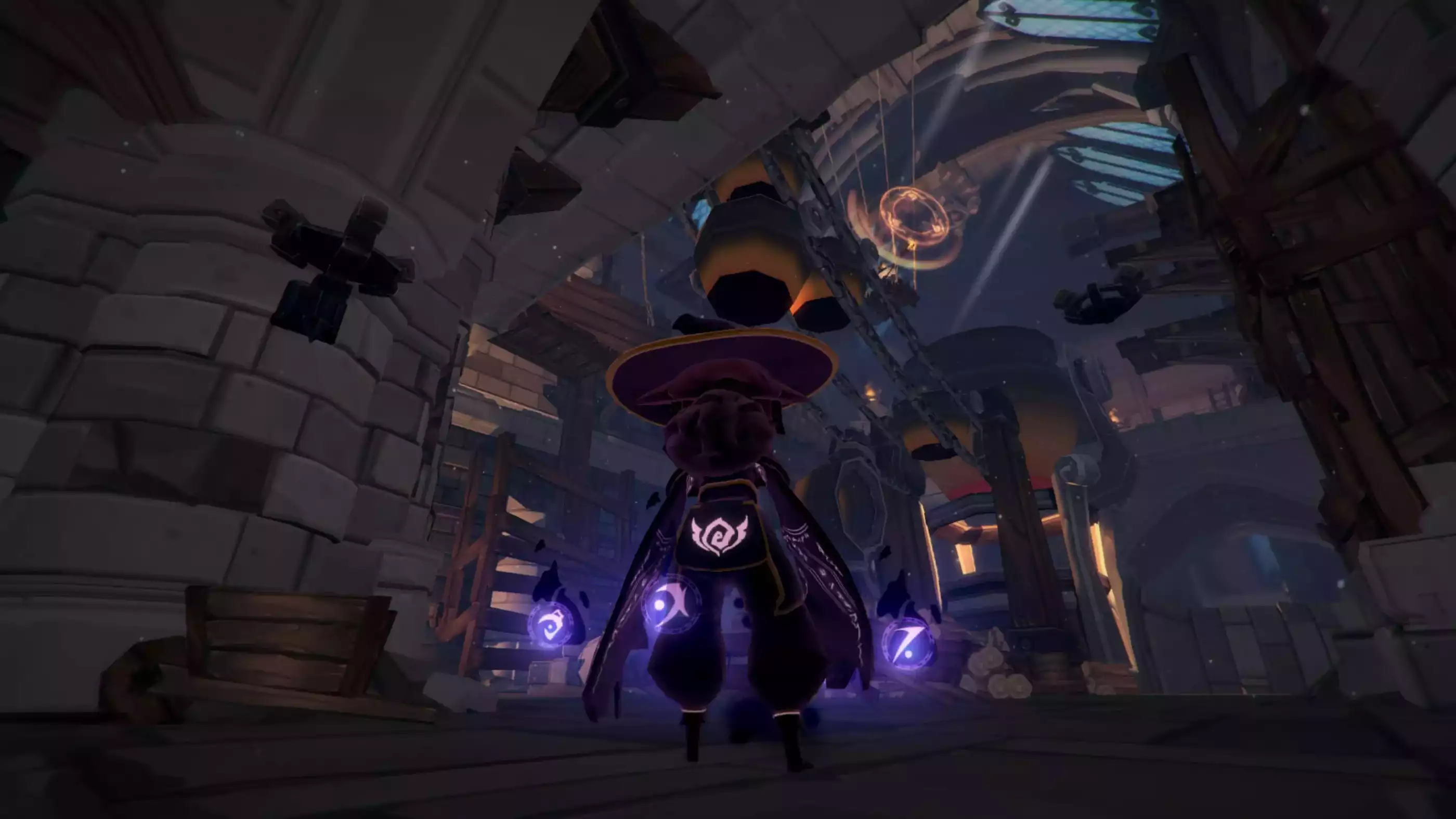 A view of the player's character in third person from behind as she stands in a large stone-and-wood structure