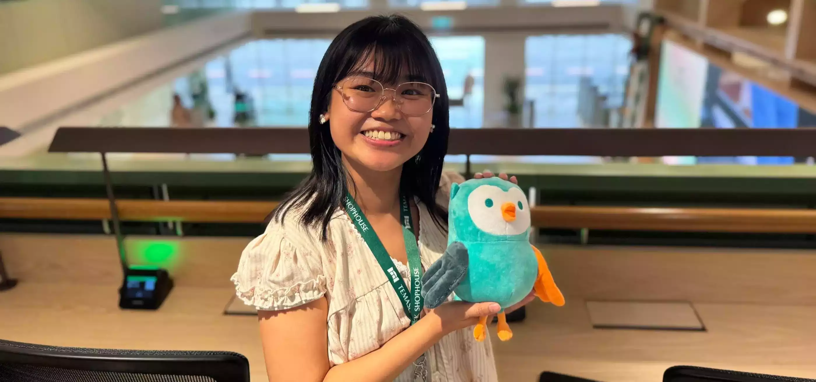 Sandy Kee holding a plush stuffed animal.